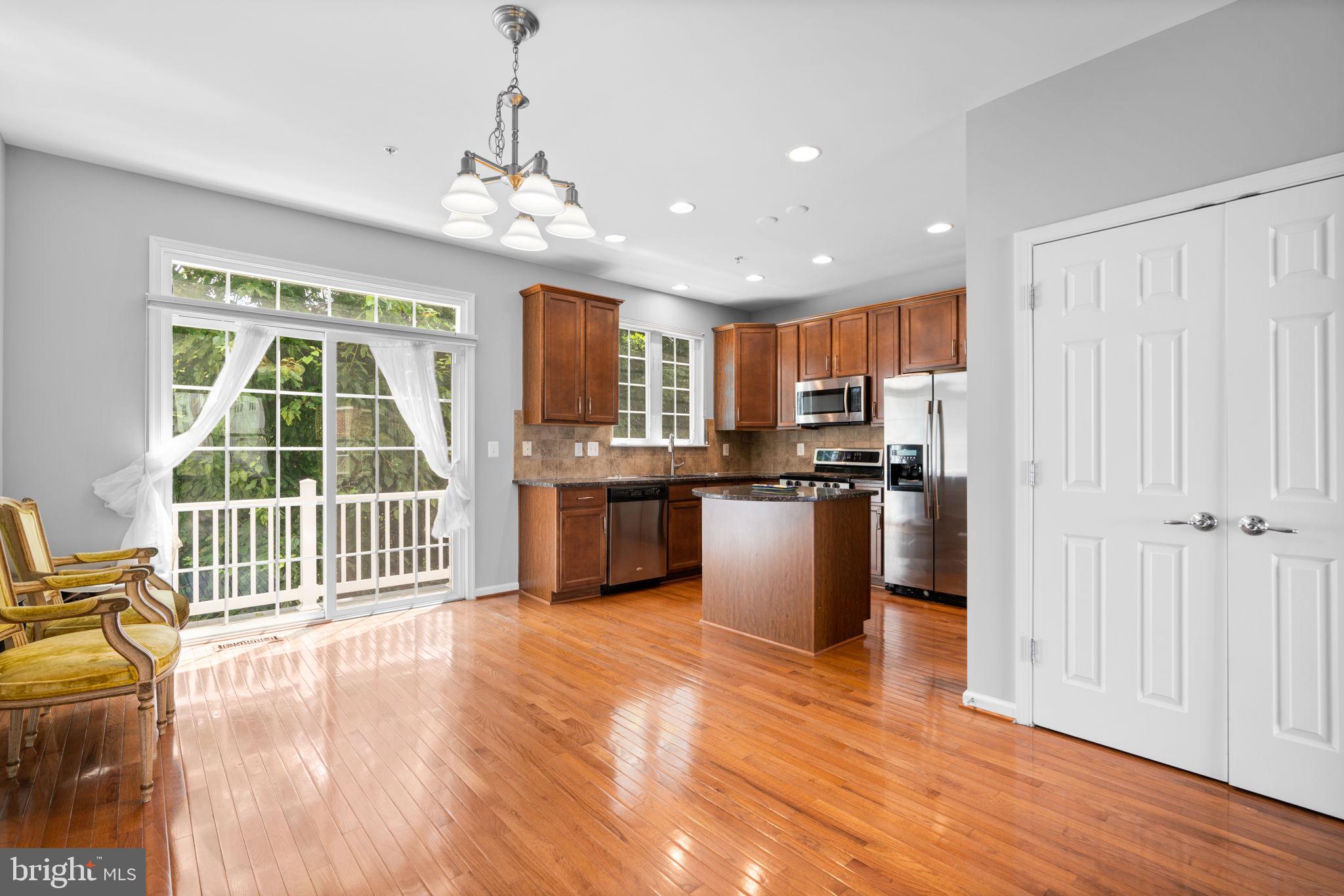 11646 Leesborough Circle Wheaton, MD 20902 - Photo 16 of 46 a open kitchen with granite countertop a stove top oven a sink and a granite counter top