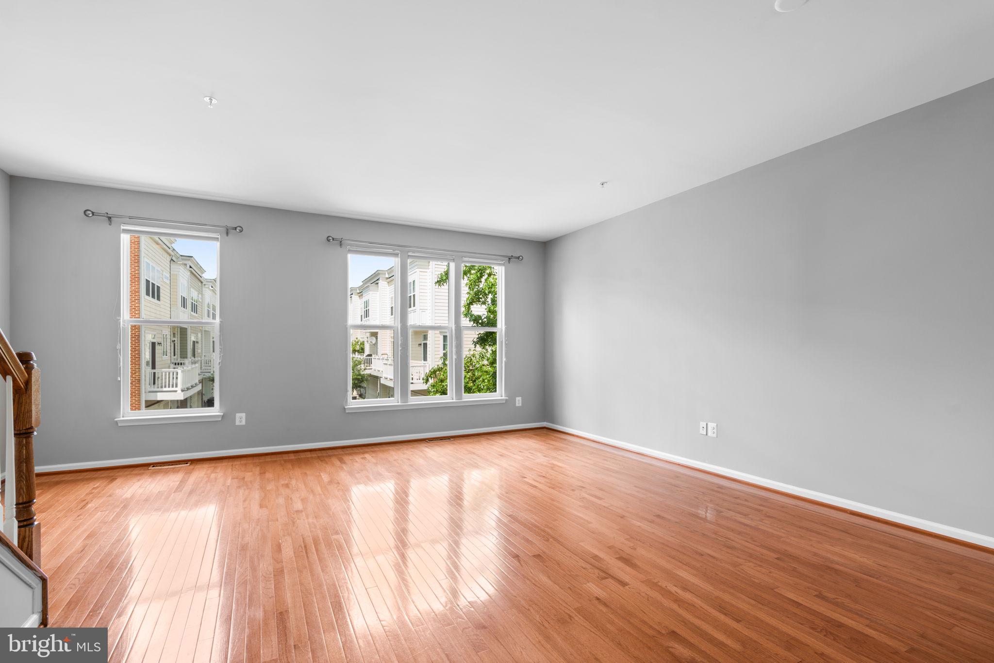 11646 Leesborough Circle Wheaton, MD 20902 - Photo 19 of 46 a view of an empty room with wooden floor and a window