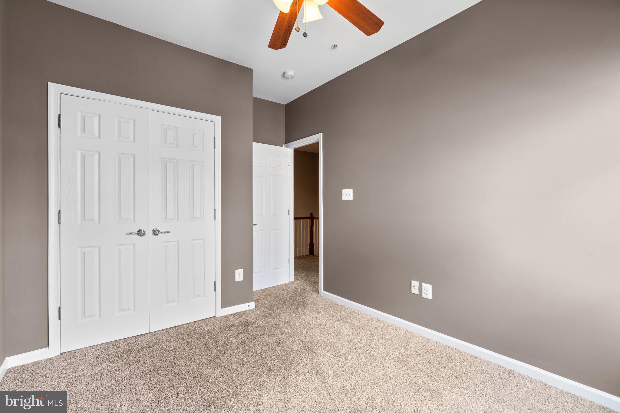 11646 Leesborough Circle Wheaton, MD 20902 - Photo 24 of 46 an empty room with closet and a chandelier fan