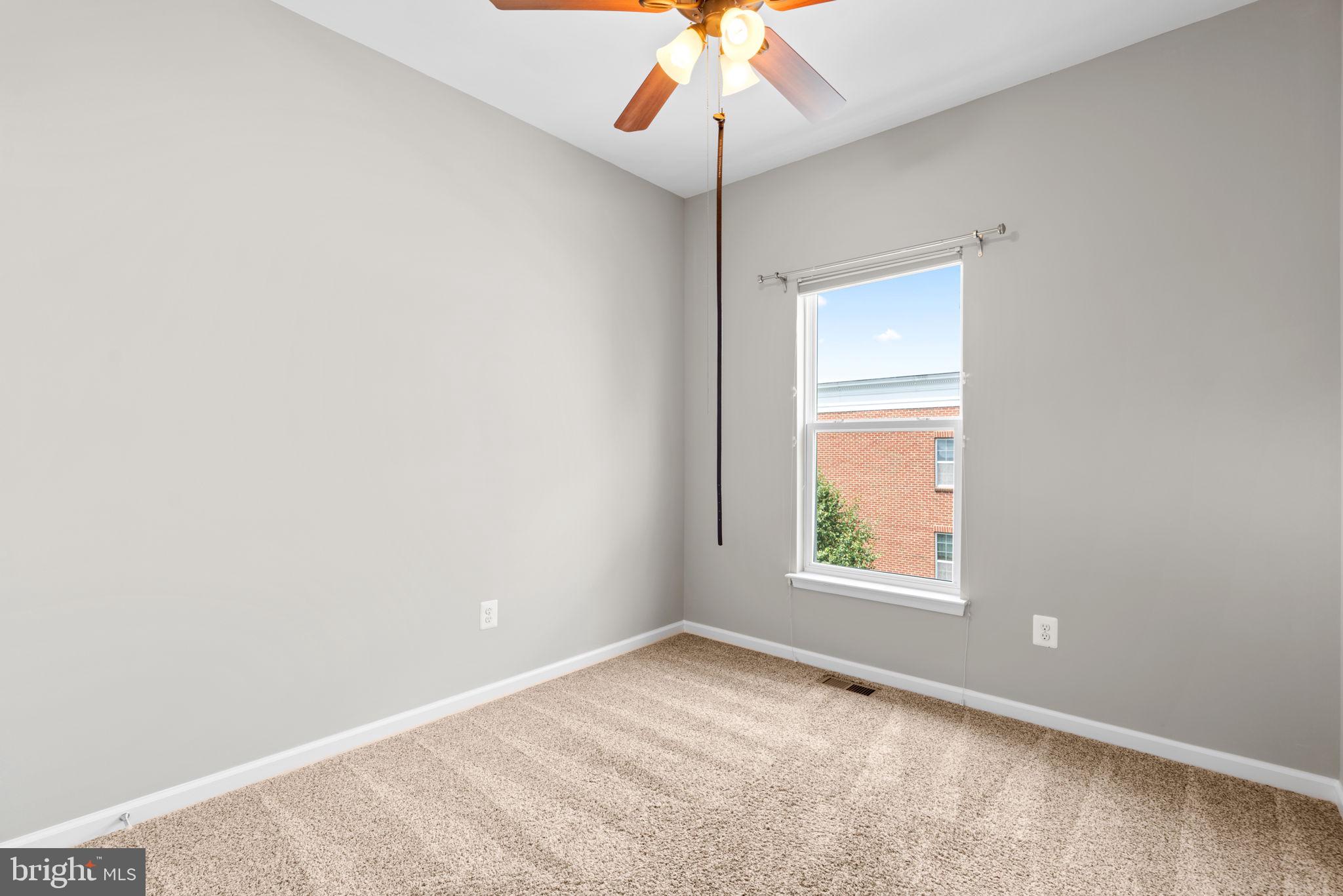 11646 Leesborough Circle Wheaton, MD 20902 - Photo 27 of 46 an empty room with a window and a fan