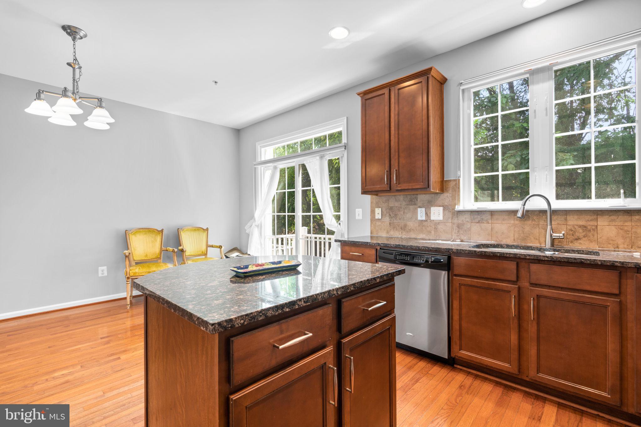 11646 Leesborough Circle Wheaton, MD 20902 - Photo 10 of 46 a kitchen with granite countertop wooden cabinets and a granite counter top
