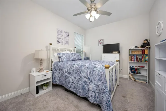 a bedroom with a bed furniture and a flat screen tv