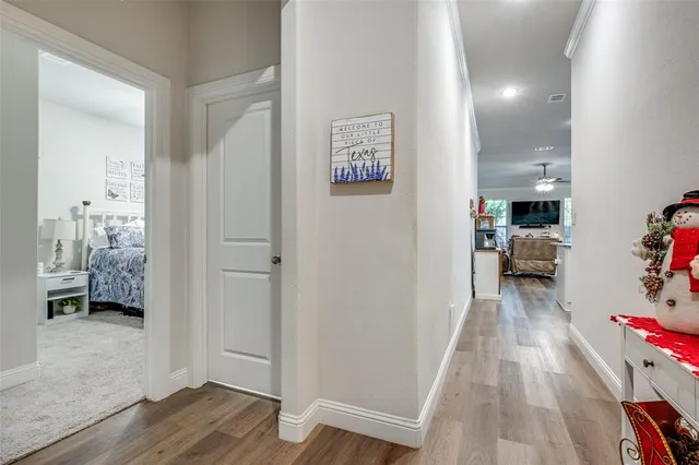 a view of hallway with wooden floor and furniture