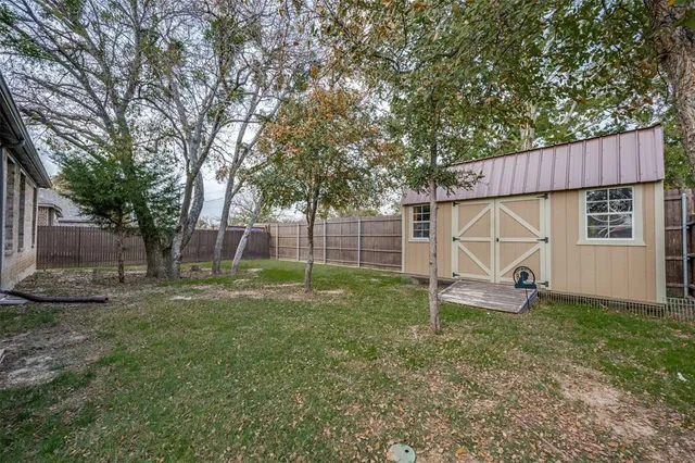 a backyard of a house with entertaining space and trampoline