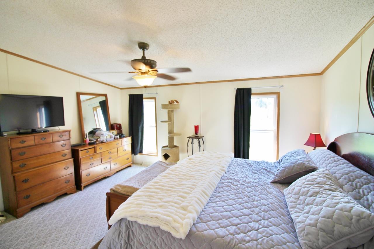 1119 Maple Hill Road Lebanon, TN 37087 - Photo 15 of 30 a bedroom with a large bed and a flat tv screen on dresser
