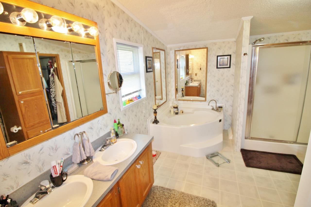 1119 Maple Hill Road Lebanon, TN 37087 - Photo 16 of 30 a bathroom with a tub sink and mirror