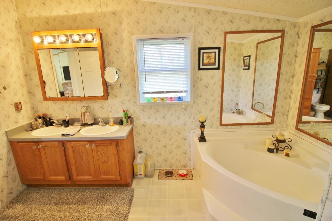 1119 Maple Hill Road Lebanon, TN 37087 - Photo 17 of 30 a bathroom with a tub sink and mirror