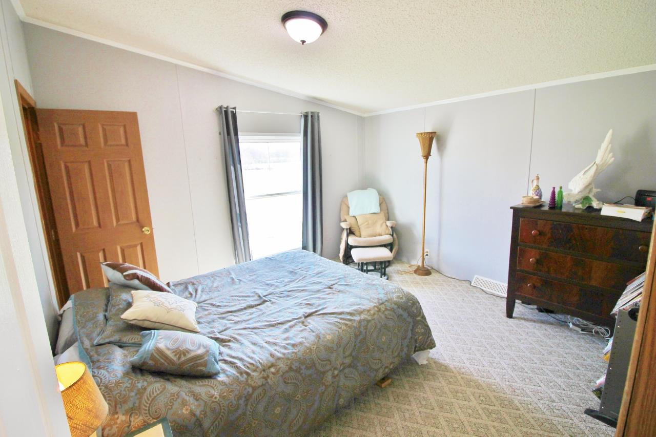 1119 Maple Hill Road Lebanon, TN 37087 - Photo 18 of 30 a bedroom with a bed and wooden floor