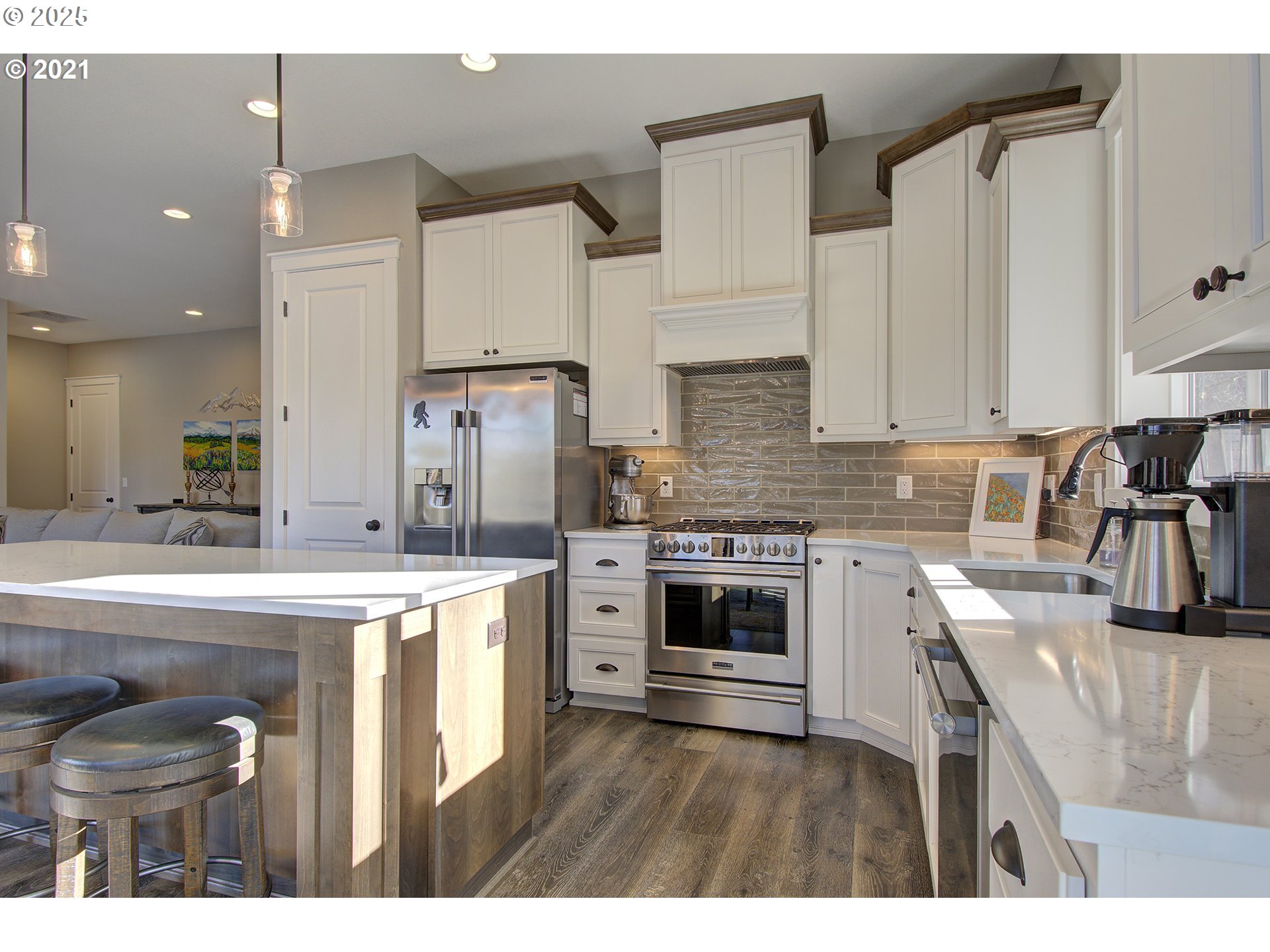 15116 Northeast Grantham Road Amboy, WA 98601 - Photo 5 of 9 a kitchen with stainless steel appliances granite countertop a stove top oven a sink a refrigerator and white cabinets with wooden floor