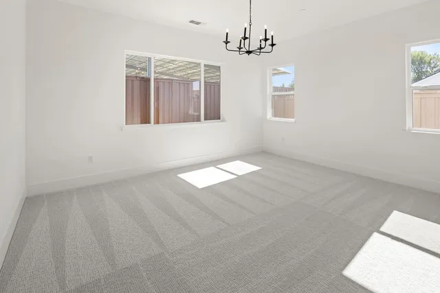 an empty room with windows and entrance