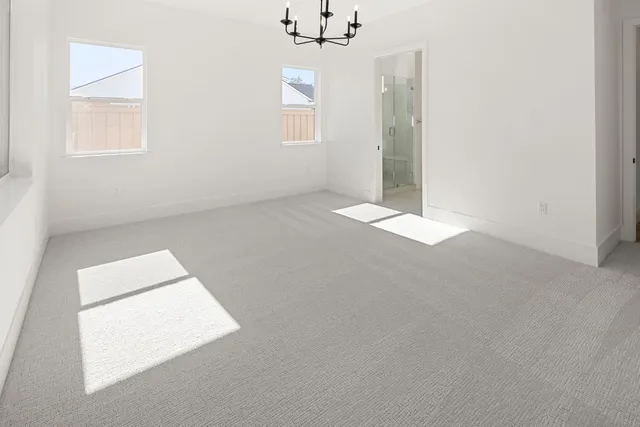 a spacious bathroom with a double vanity sink a mirror and a bathtub