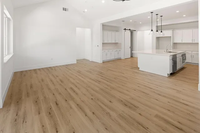 a kitchen with a sink a stove a refrigerator and cabinets