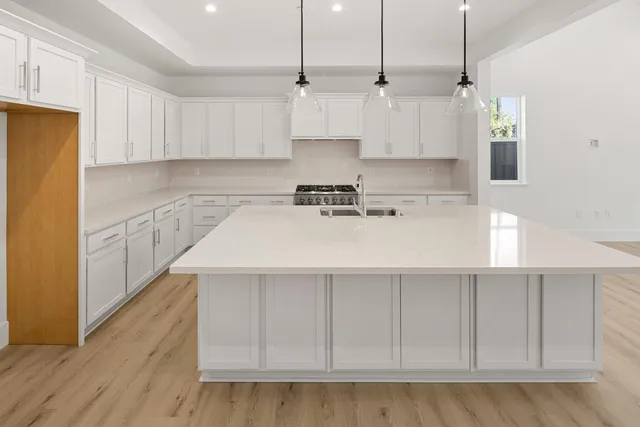 a kitchen with appliances a sink and cabinets