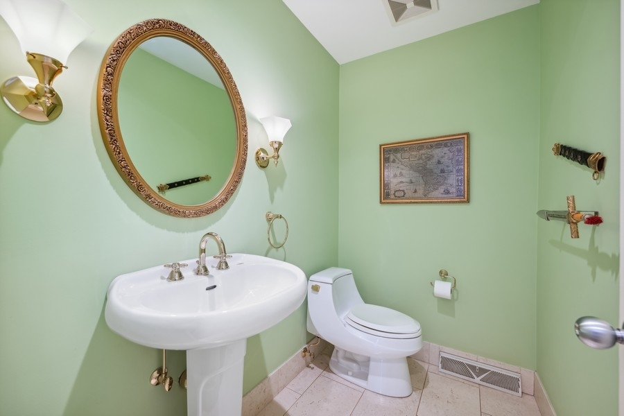 334 7 Pines Circle Highland Park, IL 60035 - Photo 11 of 19 a bathroom with a toilet sink and mirror