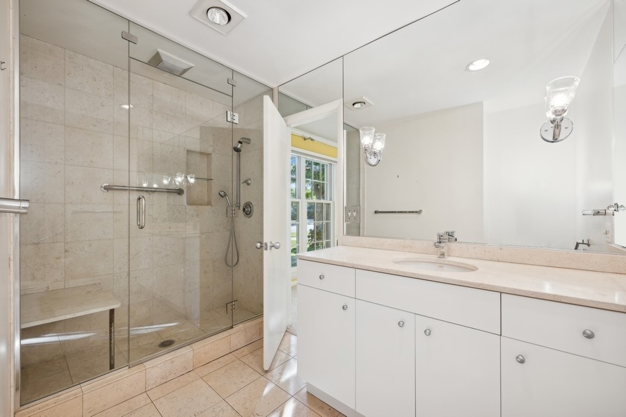 334 7 Pines Circle Highland Park, IL 60035 - Photo 14 of 19 a bathroom with a shower sink and mirror