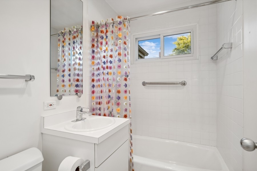 334 7 Pines Circle Highland Park, IL 60035 - Photo 7 of 19 a bathroom with a sink mirror and toilet