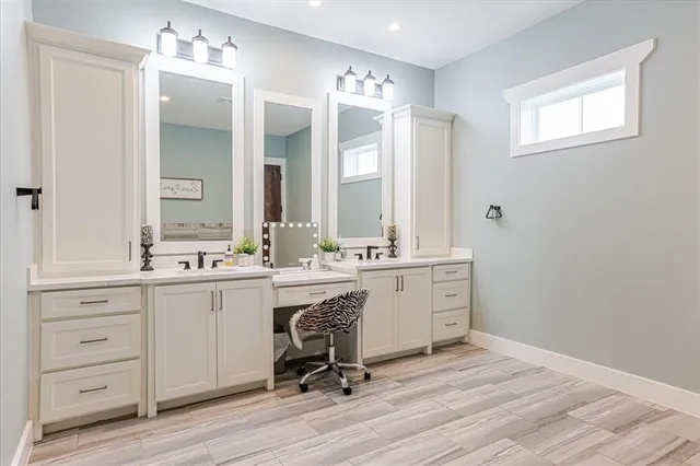 a living room with walk in closet and wooden floor