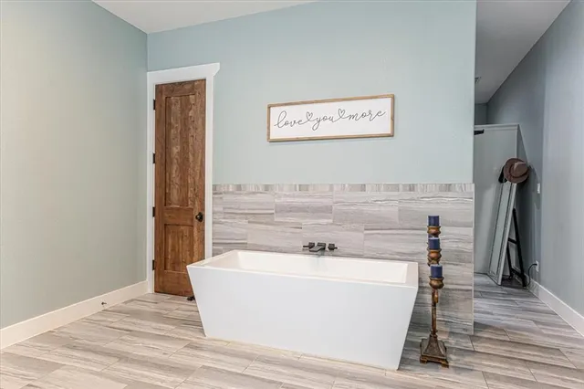 a bathroom with a granite countertop sink a toilet a mirror and shower
