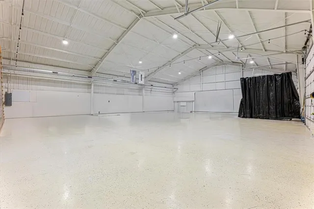 a view of swimming pool in front of residential houses with outdoor seating