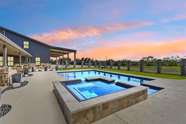 a view of swimming pool with seating area and barbeque oven