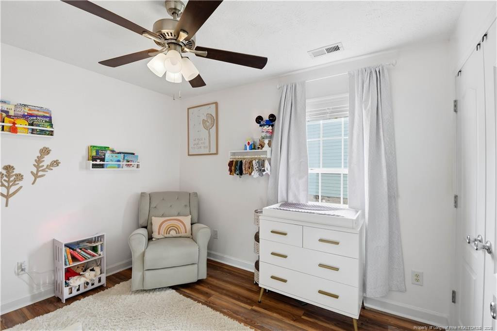 212 Lennox Loop Raeford, NC 28376 - Photo 21 of 47 a bedroom with a bed and a chandelier