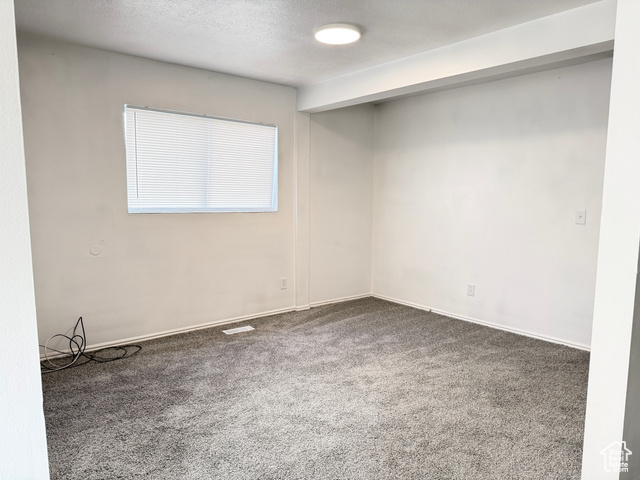 420 North 200 West Logan, UT 84321 - Photo 10 of 13 Carpeted spare room with a textured ceiling and baseboards