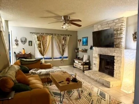 a living room with fireplace furniture and a flat screen tv