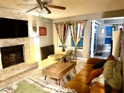 a living room with furniture a flat screen tv and a fireplace
