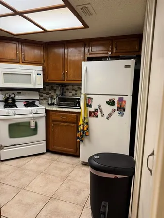 a kitchen with a stove and a refrigerator