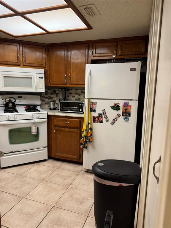 12307 Cahone Trail Austin, TX 78729 - Photo 4 of 6 a kitchen with a stove and a refrigerator