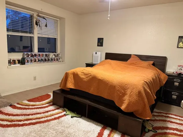 a bed sitting in a bedroom and mirror