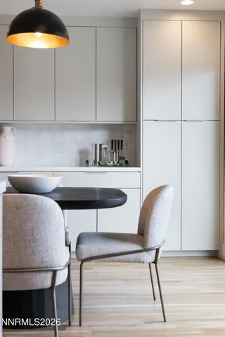 a kitchen with a table chairs and a refrigerator