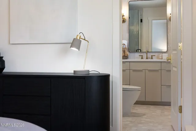 a bathroom with a sink a toilet and mirror