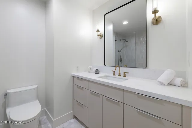 a view of a workspace with furniture and window