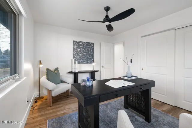 a living room with a table and a fireplace