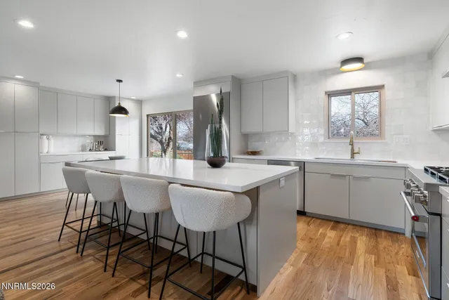 a kitchen with a table chairs refrigerator and cabinets