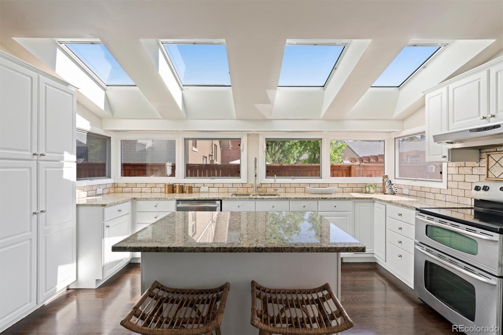 1643 South Ogden Street Denver, CO 80210 - Photo 11 of 39 a kitchen with a stove a sink and a refrigerator