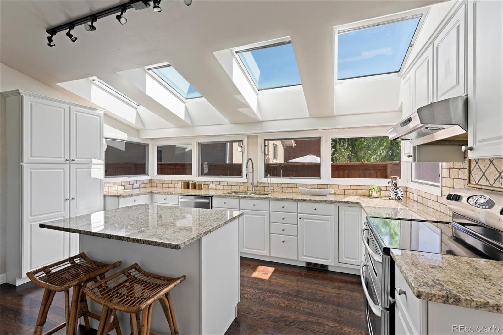 1643 South Ogden Street Denver, CO 80210 - Photo 12 of 39 a kitchen with stainless steel appliances granite countertop a stove and a sink