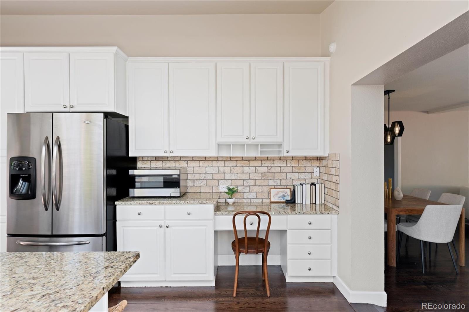 1643 South Ogden Street Denver, CO 80210 - Photo 14 of 39 a kitchen with stainless steel appliances a refrigerator and cabinets