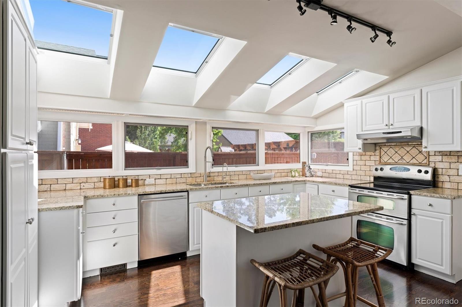 1643 South Ogden Street Denver, CO 80210 - Photo 15 of 39 a kitchen with stainless steel appliances granite countertop a stove and cabinets