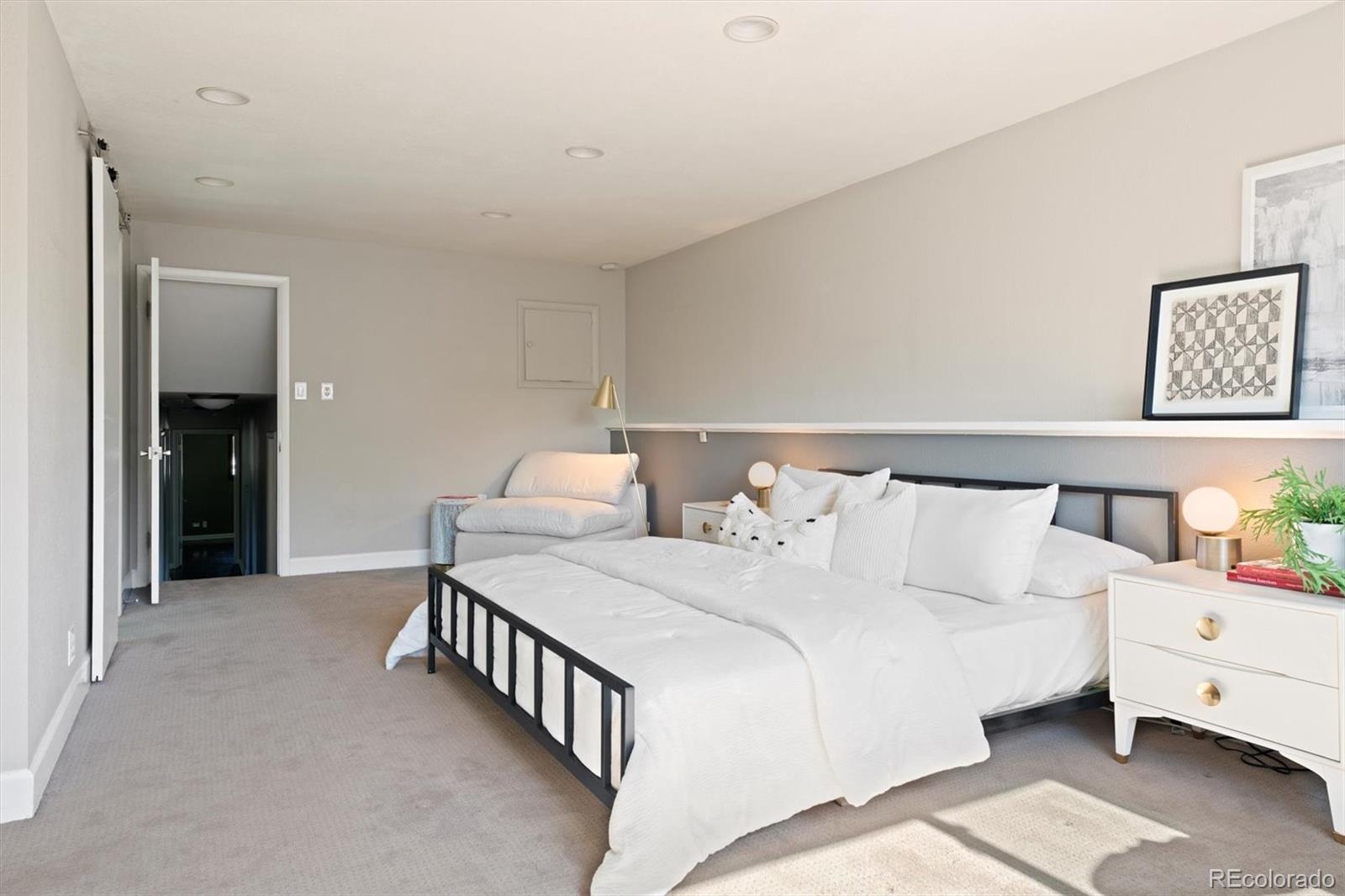 1643 South Ogden Street Denver, CO 80210 - Photo 17 of 39 a bed room with a bed and a night stand