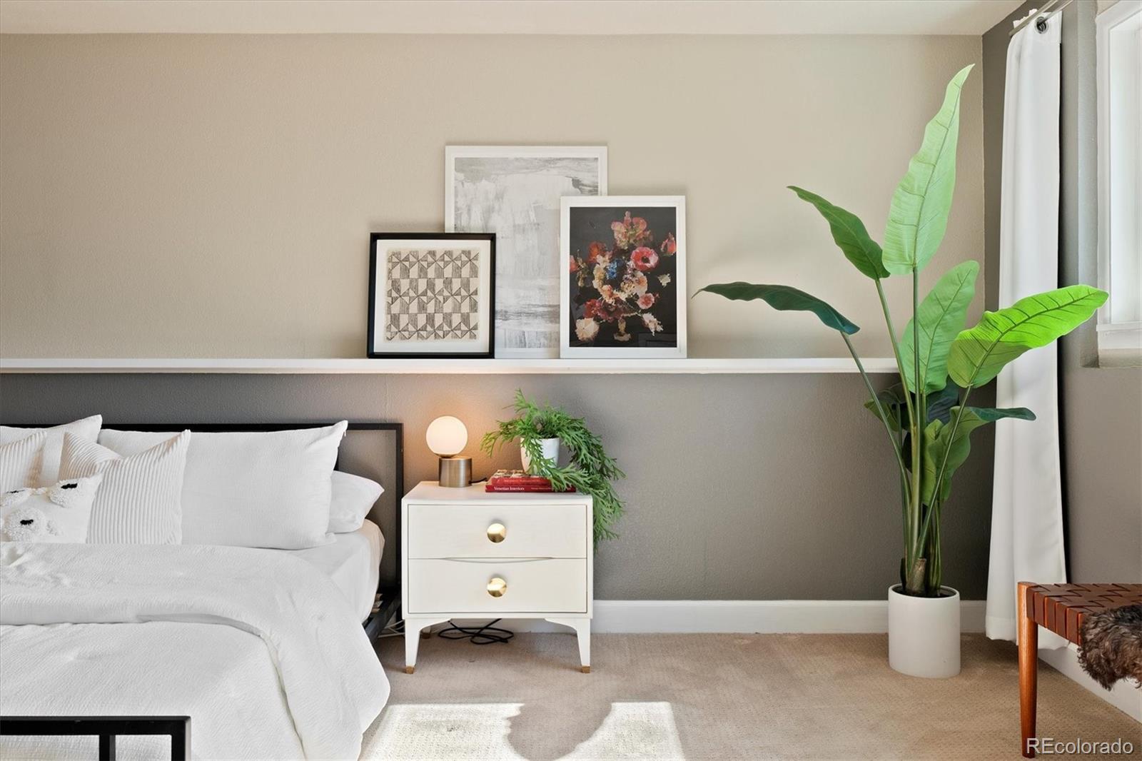 1643 South Ogden Street Denver, CO 80210 - Photo 19 of 39 a bedroom with a bed and a potted plant