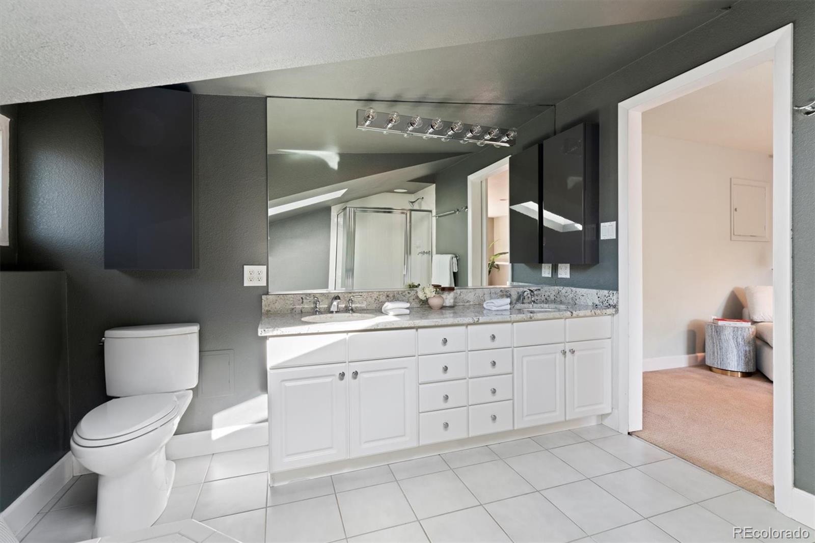 1643 South Ogden Street Denver, CO 80210 - Photo 20 of 39 a bathroom with a granite countertop sink and a toilet