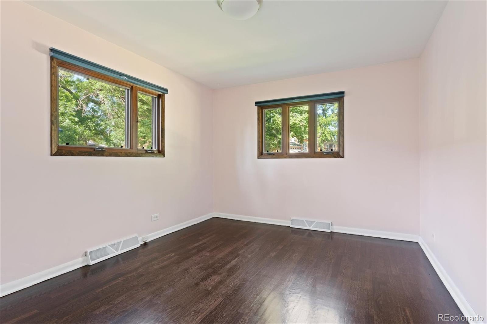 1643 South Ogden Street Denver, CO 80210 - Photo 22 of 39 an empty room with wooden floor and windows