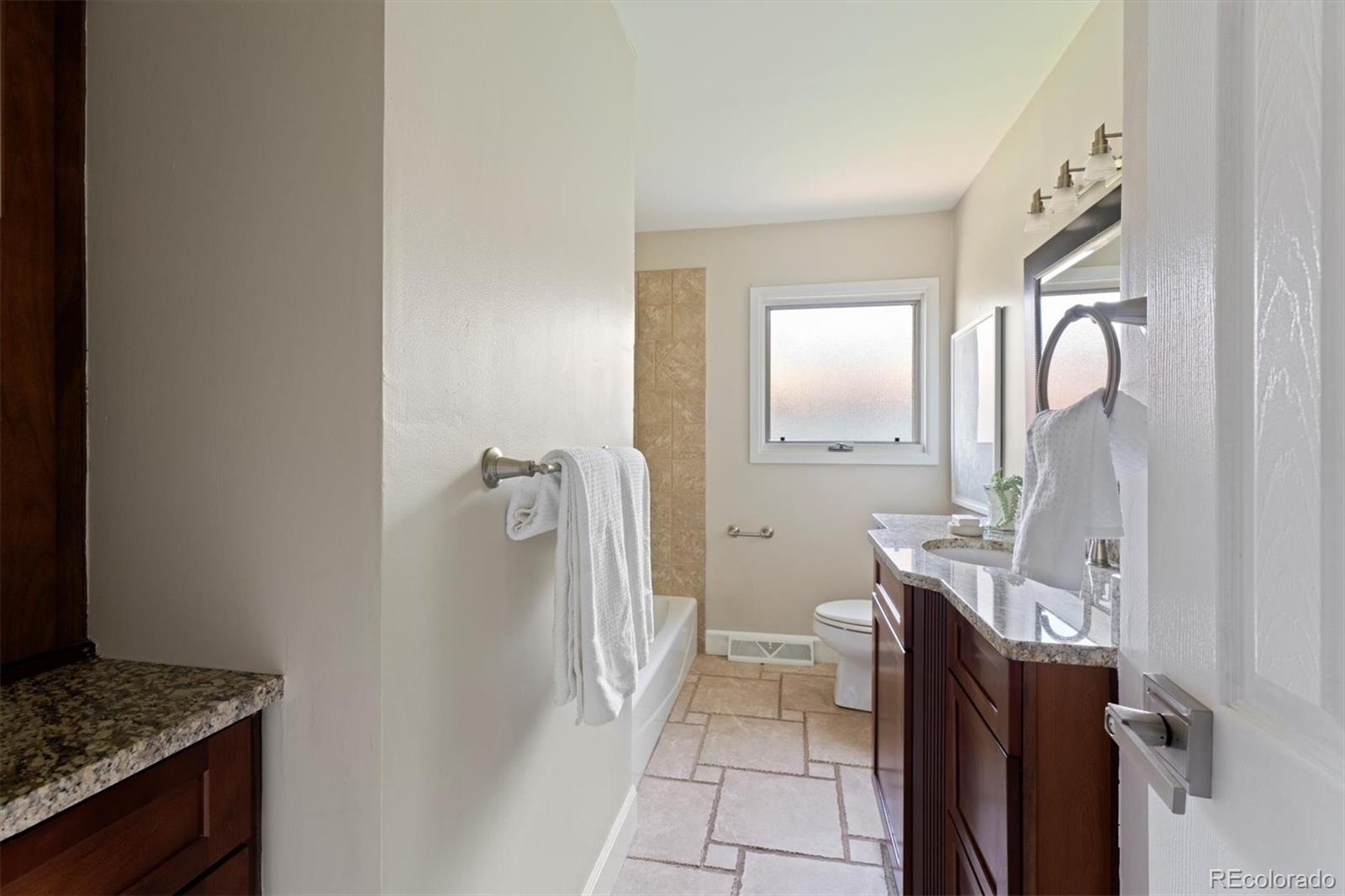 1643 South Ogden Street Denver, CO 80210 - Photo 24 of 39 a bathroom with a granite countertop sink and a mirror