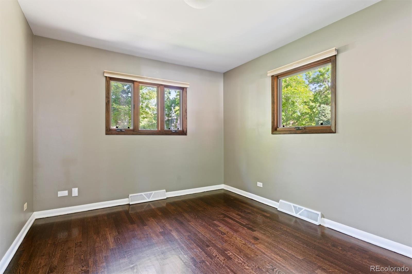1643 South Ogden Street Denver, CO 80210 - Photo 25 of 39 a view of an empty room with wooden floor and a window