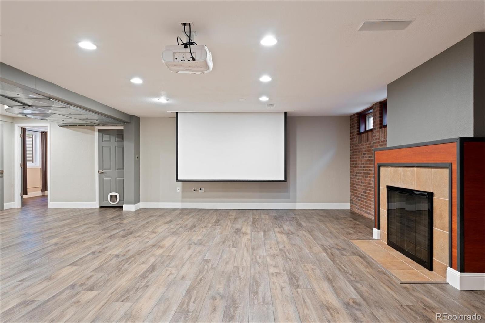 1643 South Ogden Street Denver, CO 80210 - Photo 28 of 39 a view of an empty room with wooden floor fireplace and a window