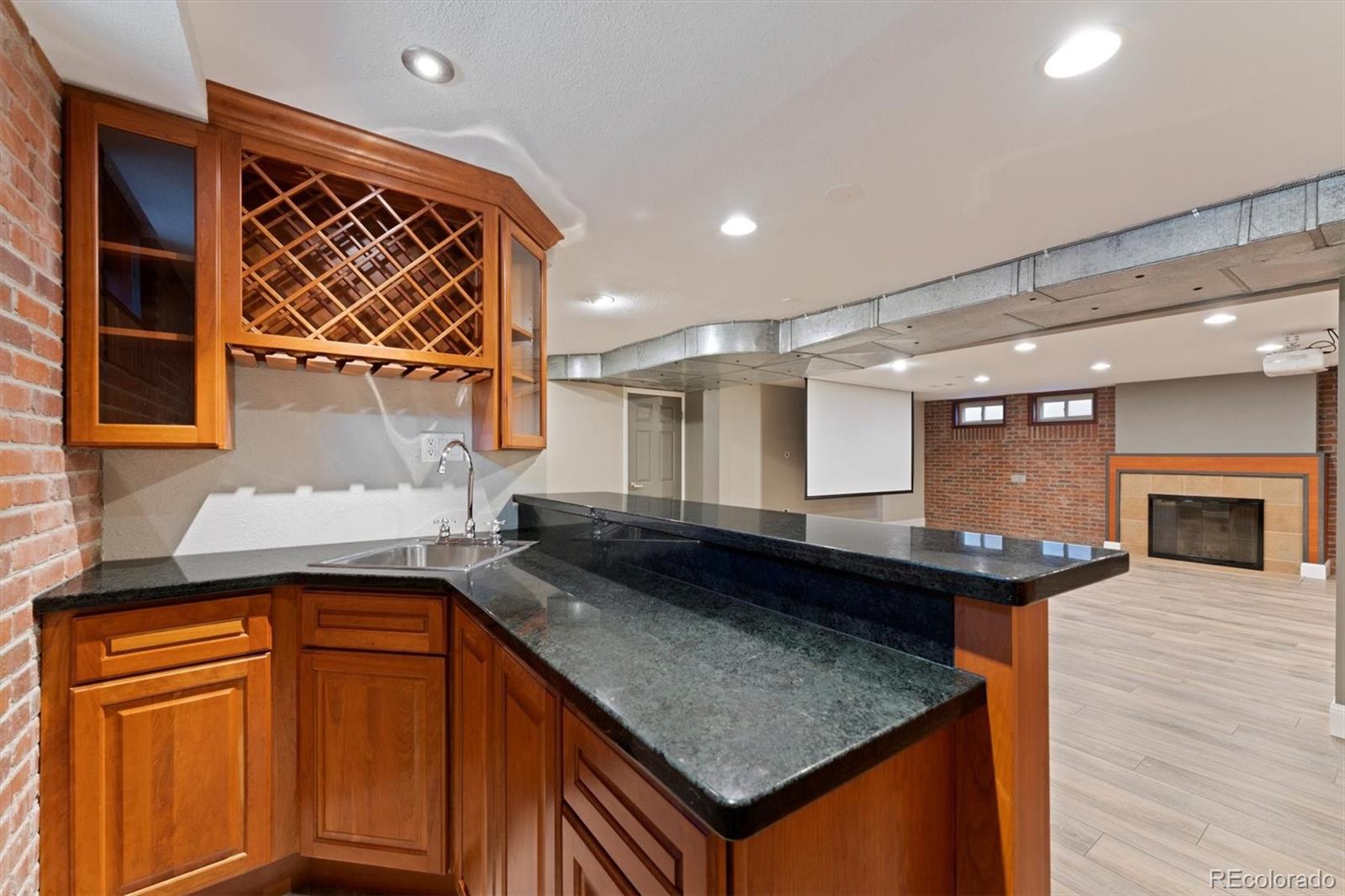 1643 South Ogden Street Denver, CO 80210 - Photo 30 of 39 a kitchen with a sink and a refrigerator
