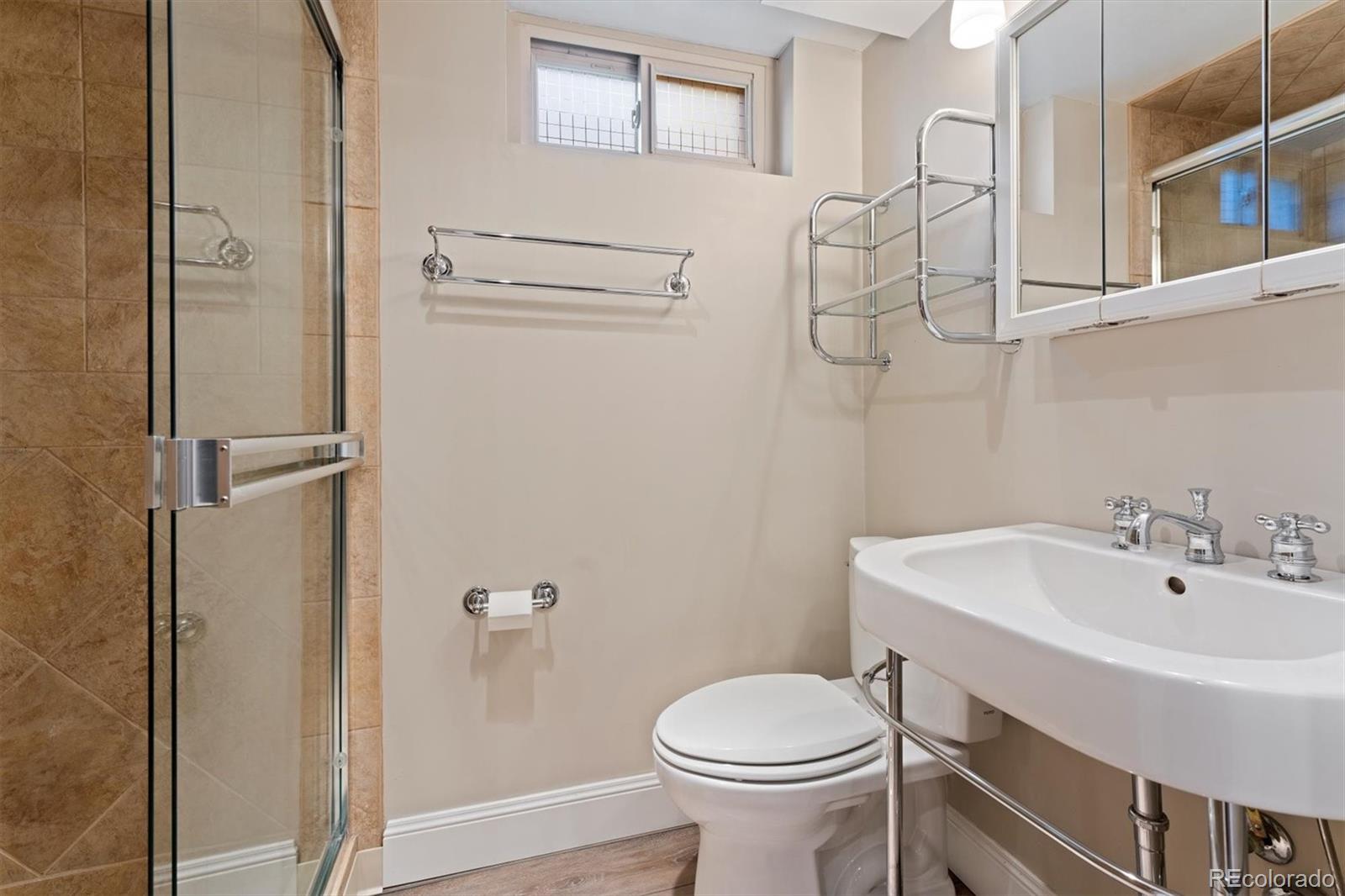 1643 South Ogden Street Denver, CO 80210 - Photo 31 of 39 a bathroom with a sink a toilet and shower
