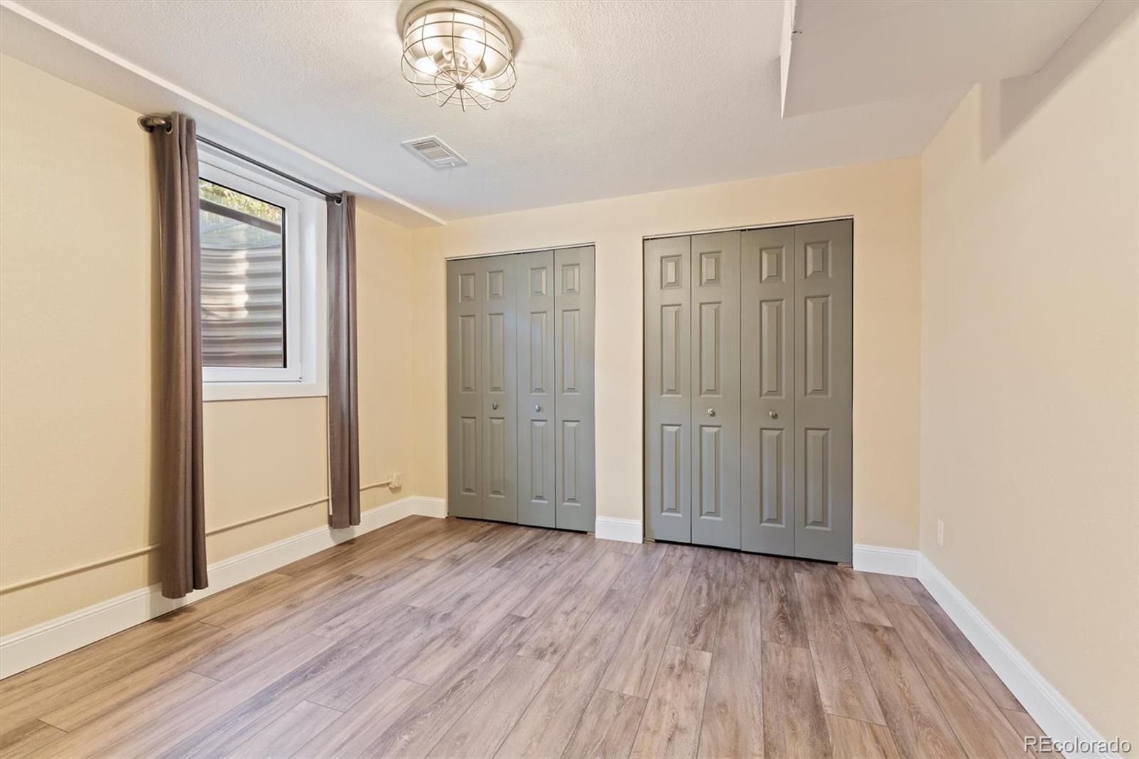 1643 South Ogden Street Denver, CO 80210 - Photo 32 of 39 wooden floor in an empty room with a window
